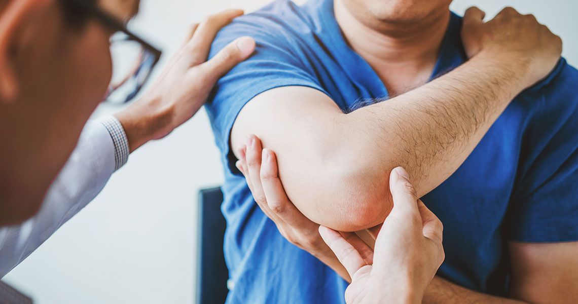 Health Provider checking a patient’s elbow
