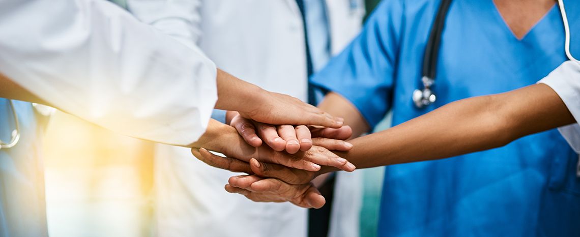 Doctors' hands stacked