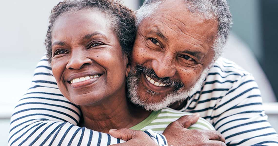 A couple embracing and smiling