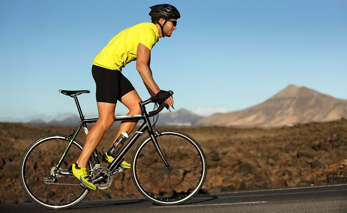 A cyclist biking up a road