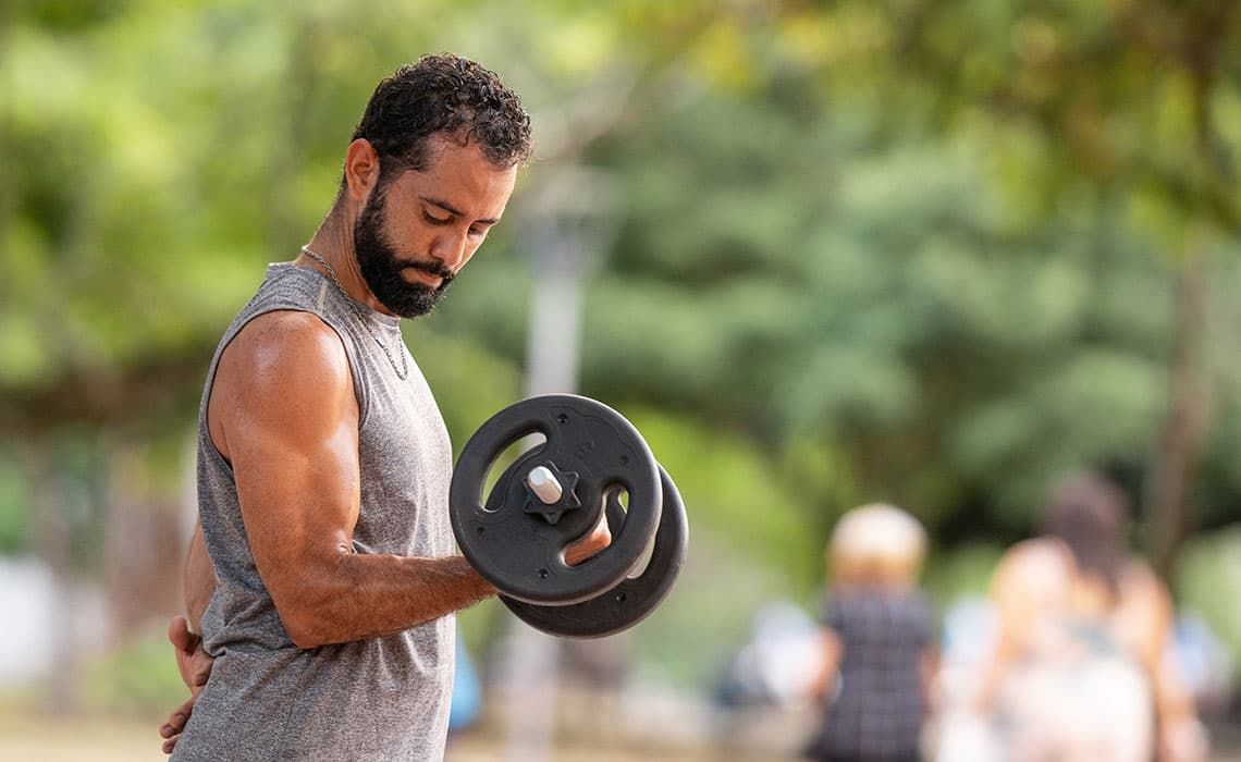 A man performing a single-arm bicep curl with a weight
