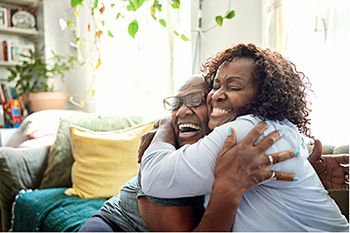 Two people smiling and hugging