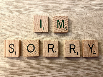 scrabble letters spelling I'm Sorry