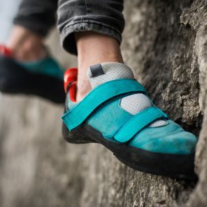 Mountain climber's shoe gripping a rock face