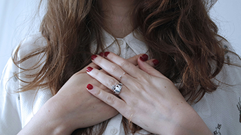 person with hands on chest