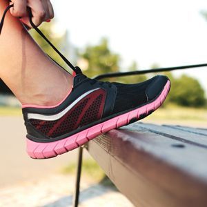 A running shoe being tied